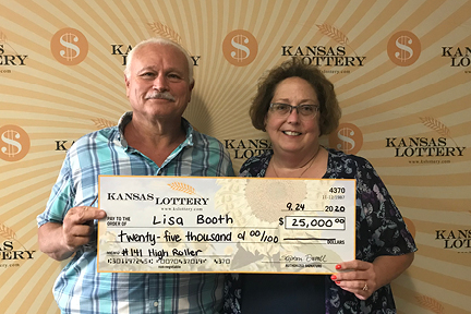 Lisa Booth, standing with husband, Danny, after she won $25,000